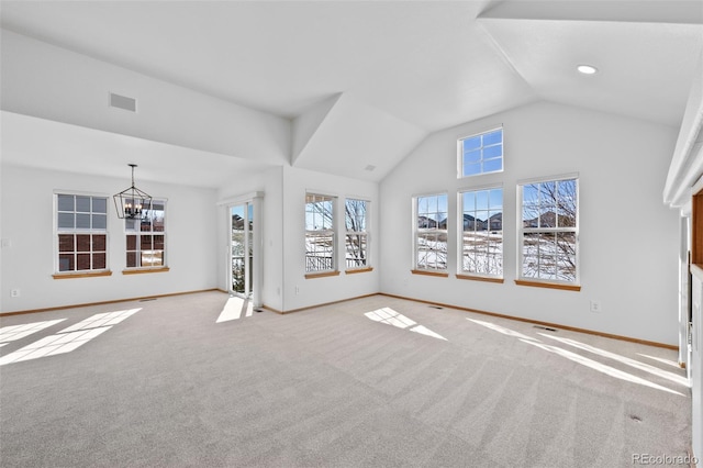 unfurnished living room featuring an inviting chandelier, lofted ceiling, and light carpet