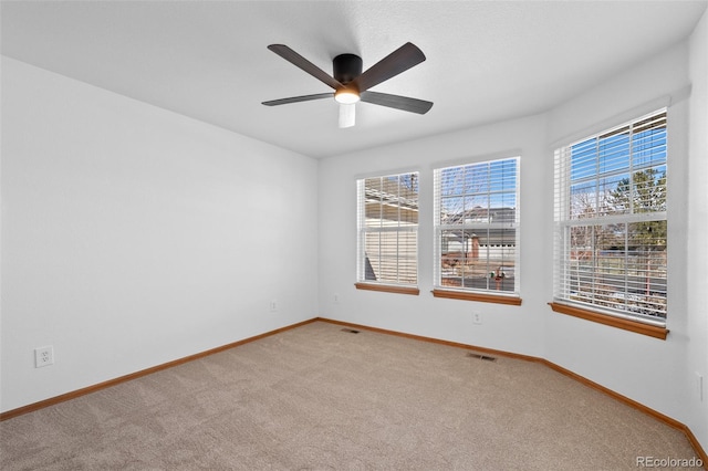 carpeted empty room with ceiling fan