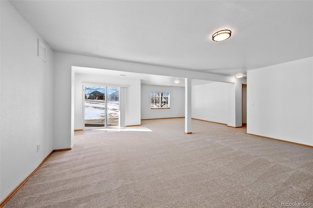 basement featuring light carpet