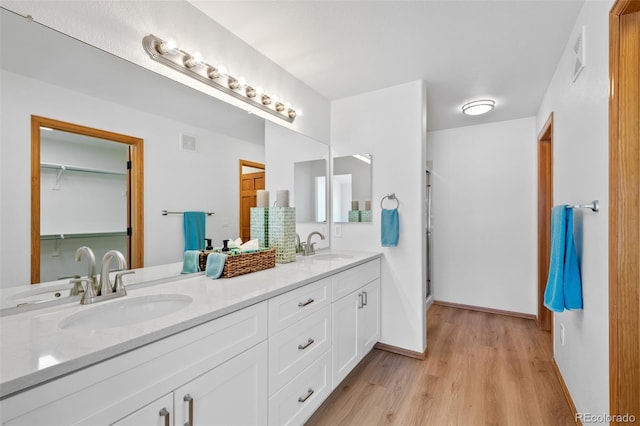 bathroom featuring vanity, an enclosed shower, and hardwood / wood-style floors