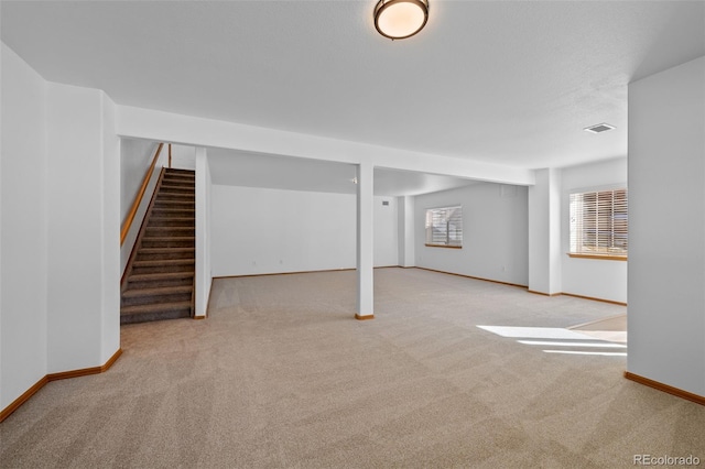 basement featuring light carpet