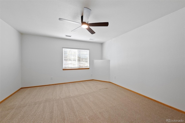 carpeted spare room with ceiling fan