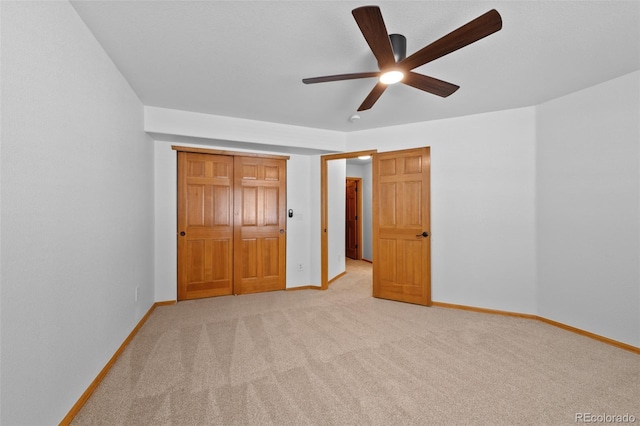 unfurnished bedroom with light carpet and ceiling fan