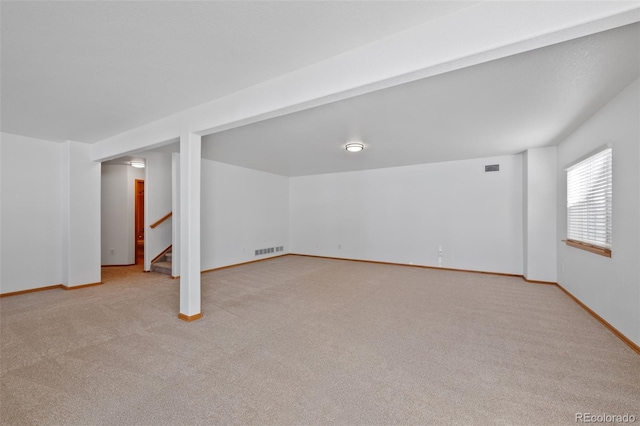 basement featuring light colored carpet