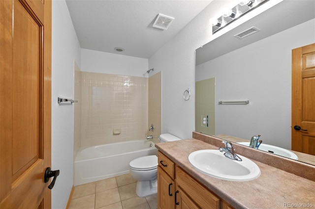 full bathroom with vanity, tiled shower / bath, tile patterned floors, and toilet