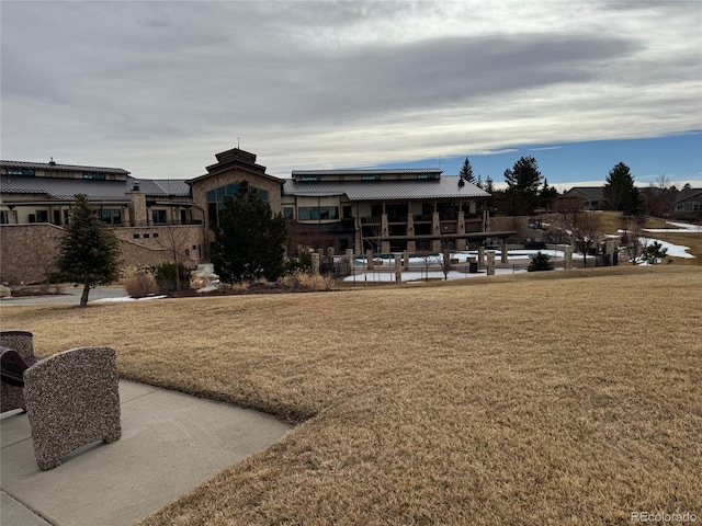 view of home's community with a yard