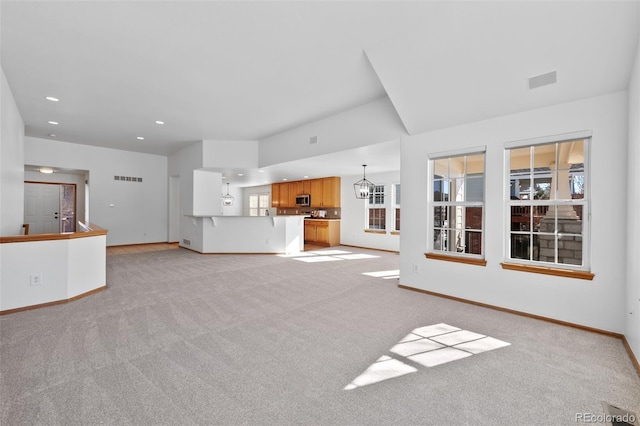7879 S Zante Ct, Aurora, CO 80016 - unfurnished living room featuring light carpet, a chandelier, baseboards, recessed lighting, and healthy amount of natural light