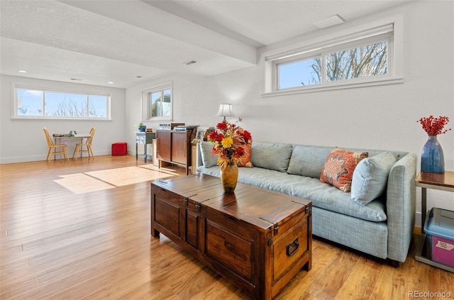 living room with light wood-style flooring and baseboards