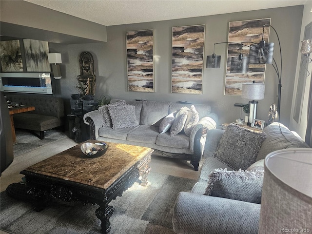 carpeted living room with a textured ceiling