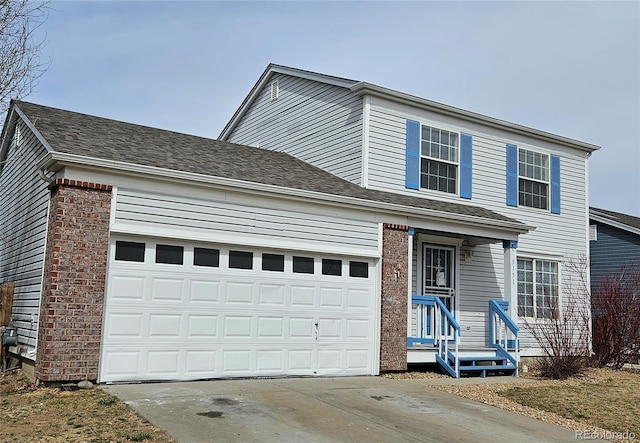 traditional-style home featuring a garage and concrete driveway