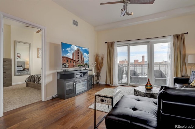 living room featuring hardwood / wood-style floors and ceiling fan