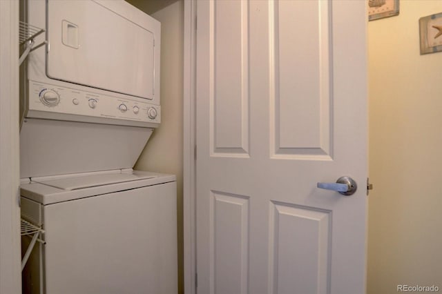 clothes washing area featuring stacked washing maching and dryer