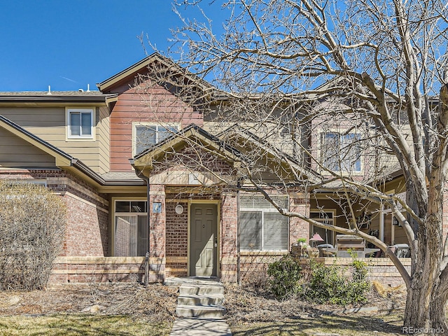 view of front of house featuring brick siding