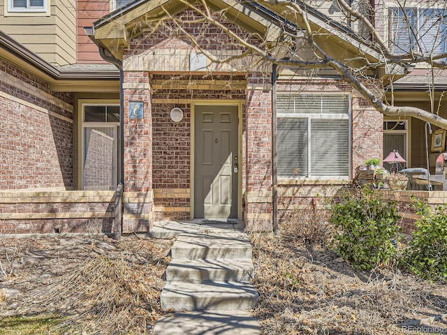 entrance to property with brick siding