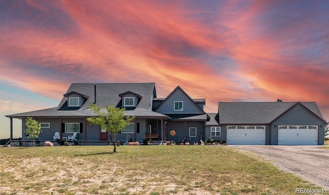 view of front of house featuring a garage and a lawn