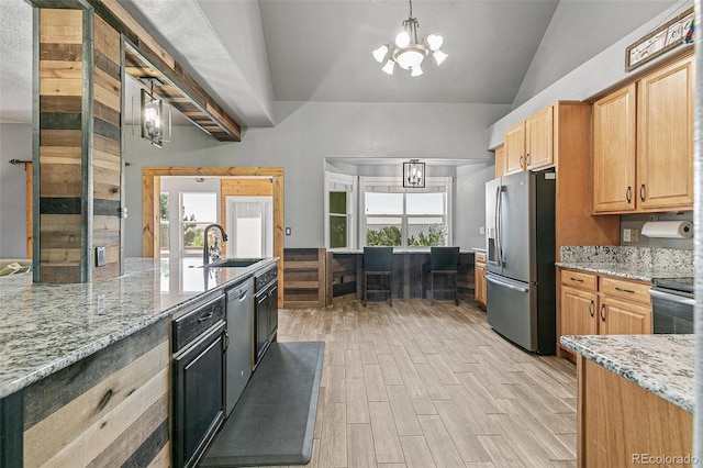 kitchen featuring pendant lighting, a chandelier, light stone countertops, and stainless steel appliances