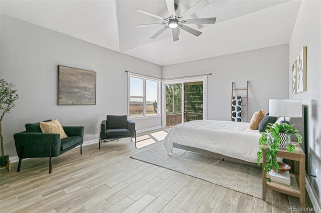 bedroom with ceiling fan, access to outside, and vaulted ceiling