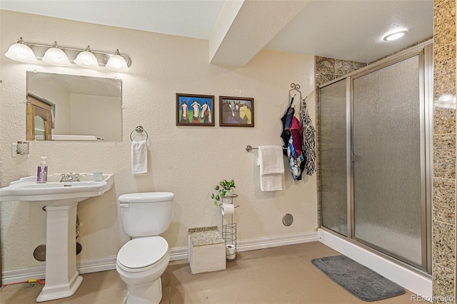 bathroom featuring sink, toilet, and walk in shower