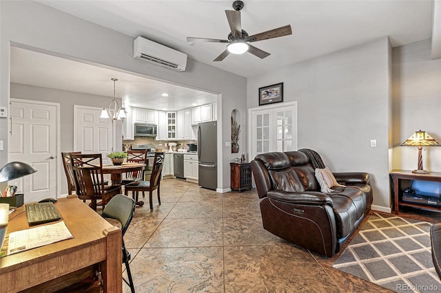 living room with french doors, ceiling fan with notable chandelier, and a wall mounted AC