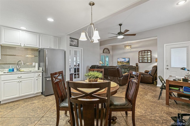 dining space featuring sink, ceiling fan, and french doors