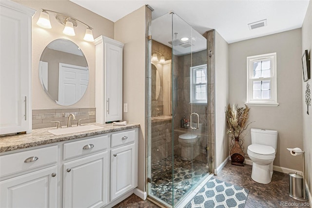 bathroom featuring vanity, toilet, an enclosed shower, and backsplash