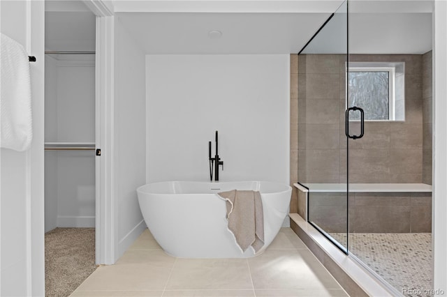 bathroom featuring plus walk in shower and tile patterned floors