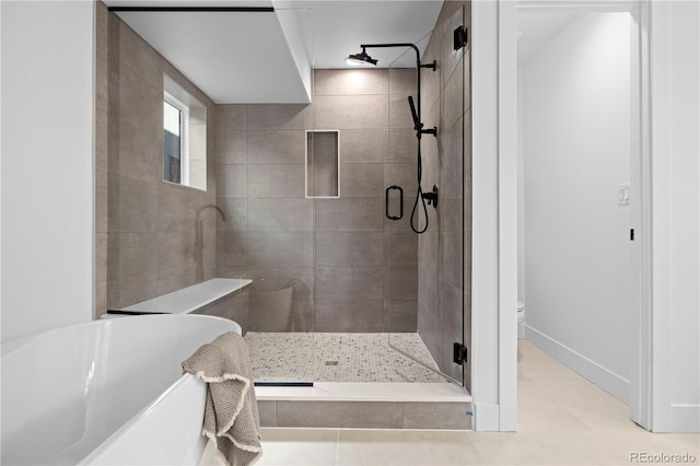 bathroom with walk in shower and tile patterned floors