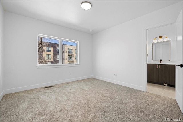 empty room with light colored carpet