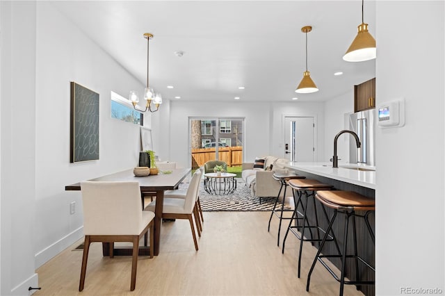 dining area featuring sink and light hardwood / wood-style floors