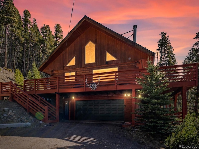 451 Harris Dr, Idaho Springs, CO 80452 - view of front of house featuring an attached garage, a deck, and driveway