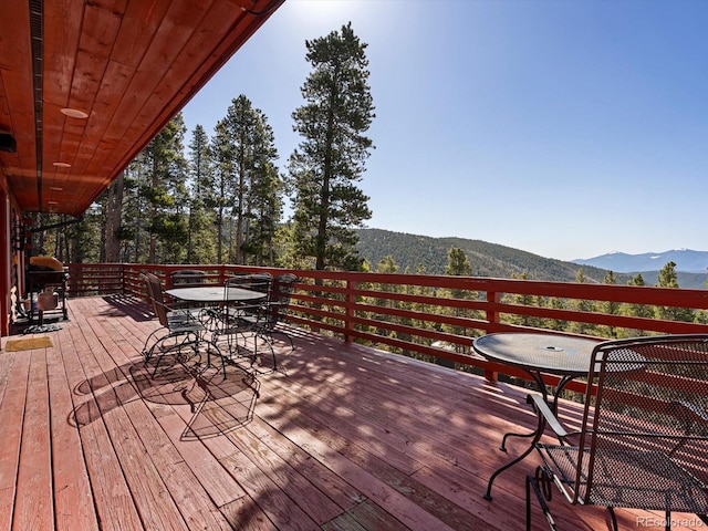 451 Harris Dr, Idaho Springs, CO 80452 - wooden terrace with a mountain view, outdoor dining area, and a grill