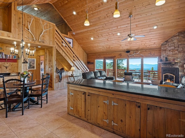 451 Harris Dr, Idaho Springs, CO 80452 - kitchen featuring wood ceiling, dark countertops, a fireplace, open floor plan, and high vaulted ceiling
