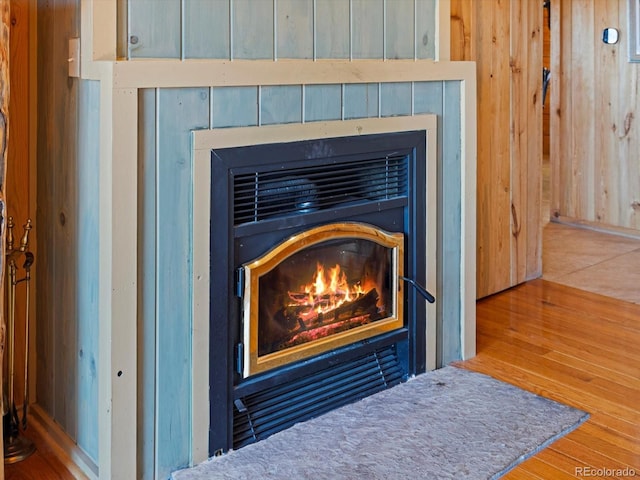 451 Harris Dr, Idaho Springs, CO 80452 - detailed view of a glass covered fireplace, wood finished floors, and wooden walls
