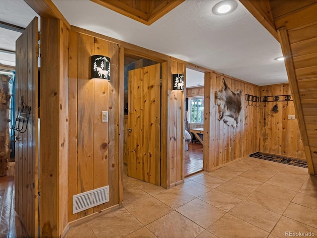 451 Harris Dr, Idaho Springs, CO 80452 - hall with wood walls and light tile patterned floors