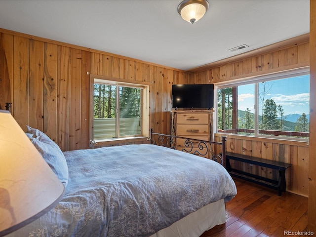 451 Harris Dr, Idaho Springs, CO 80452 - bedroom featuring wood walls and hardwood / wood-style floors