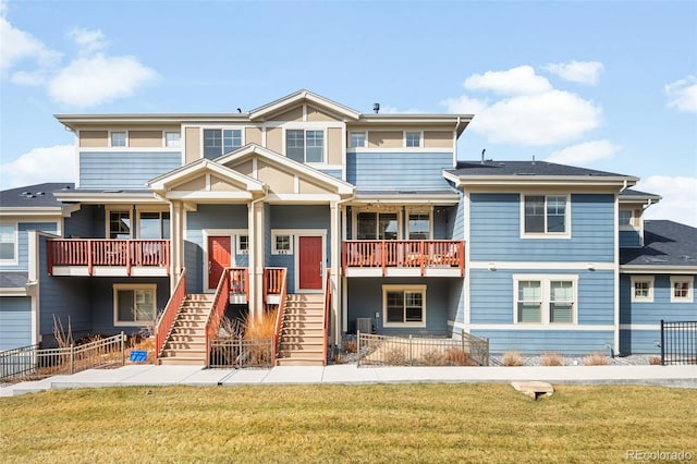 view of front of house featuring stairs, a front yard, and fence