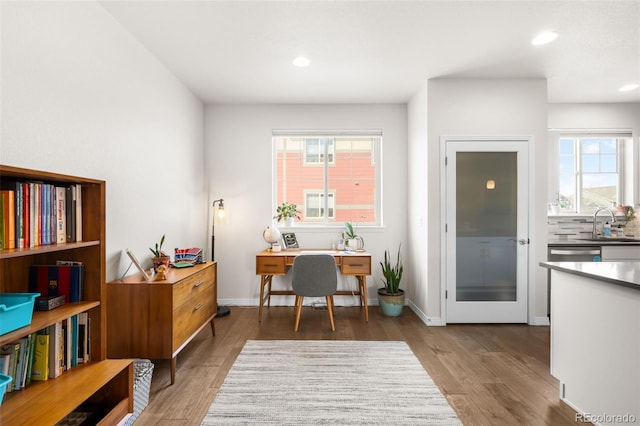 office space with recessed lighting, wood finished floors, and baseboards