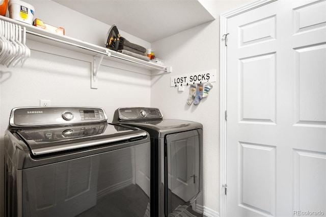 clothes washing area with washing machine and dryer and laundry area