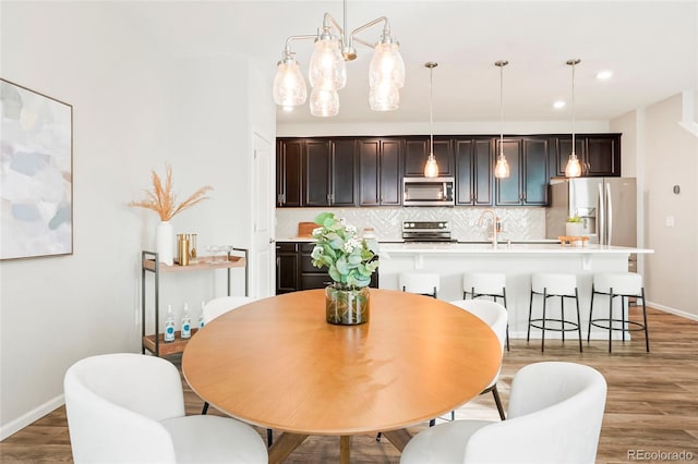 dining space with wood-type flooring