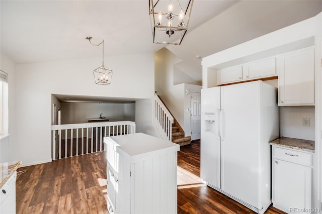 interior space featuring a kitchen island, pendant lighting, lofted ceiling, white cabinets, and white refrigerator with ice dispenser