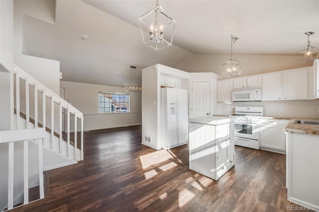 kitchen with white cabinetry, hanging light fixtures, white appliances, and a notable chandelier