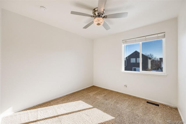 empty room with ceiling fan and carpet flooring