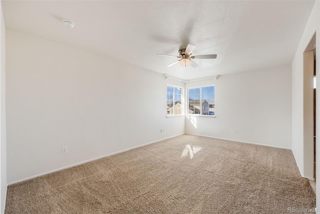 carpeted spare room with ceiling fan and a textured ceiling