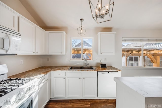 kitchen featuring sink, light stone counters, pendant lighting, white appliances, and white cabinets