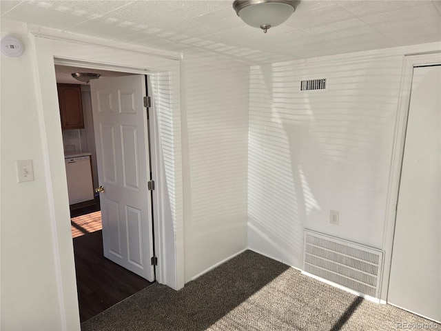 corridor with dark colored carpet