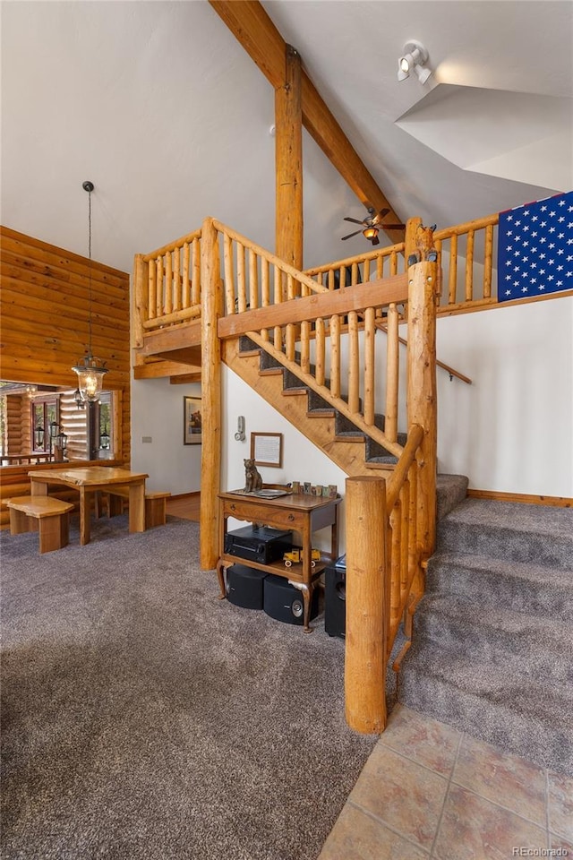 stairs with carpet, ceiling fan, and high vaulted ceiling