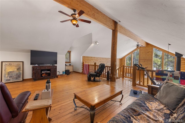 living room featuring wood-type flooring, a ceiling fan, and vaulted ceiling with beams