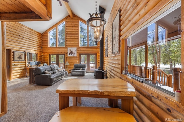 living area featuring beam ceiling, log walls, high vaulted ceiling, and carpet floors