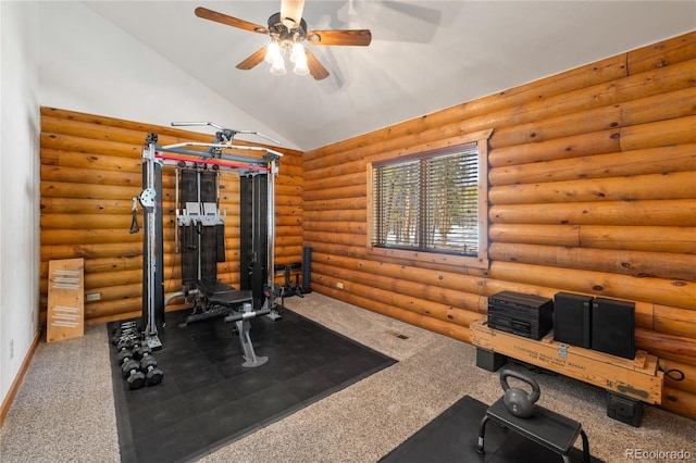 exercise area featuring rustic walls, a ceiling fan, carpet floors, and vaulted ceiling