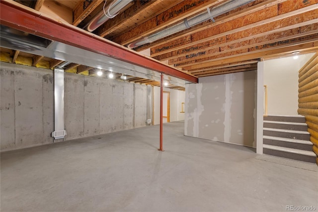 unfinished basement featuring stairway